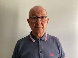 Thanks first. Can someone edit my picture and put a suit and white  background, because I need for visa documentation.