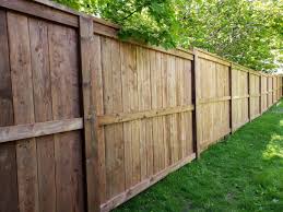 Easy to cover for a perfect Fence Our Company Built Today With Master Halco Postmaster Posts With Brown Pressure Treated Lumber Fence