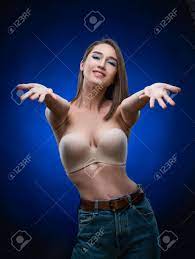 Beautiful Mixed Race Asian Girl With Big Breasts, Wearing A Bra And Jeans,  Smiles And Holds Out Her Hands Forward. Advertising, Commercial Design  Stock Photo, Picture and Royalty Free Image. Image 134595364.