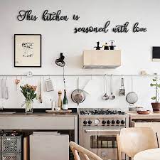 With a neutral black finish, this flowing cursive word art is inspirational and uplifting and will complement any style of interior design, from modern rustic to vintage farmhouse chic. This Kitchen Is Seasoned With Love Kitchen Wall Decor Metal Wall Decor Kitchen Wall