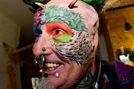 Animal lover with more than 100 tattoos gets his ears chopped off to look  like his parrots