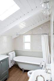 Before he could mount the shower curtain ring, richard used a tubing cutter to make it shorter so that it would fit underneath a slanted ceiling directly above the tub. Vintage Clawfoot Tub With A Vintage Oval Shower Curtain Rod In Charming Bathroom Designed With White Sloped Ceiling Bathroom Clawfoot Tub Clawfoot Tub Bathroom
