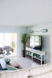 Ripped out the carpet and padding and replaced with laminate wood floors. Beach Condo Living Room Decor Before And Afters The Lilypad Cottage