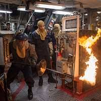 Engineman 1st Class Daniel Citizen from Lafayette, La., front, and  Engineman 2nd Class David Larson, from Bigelow, Ark., prepare the main  machinery room number 2 operating station for an operational test. -