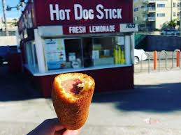 The employees' uniforms are the main source of color. Hot Dog On A Stick Pacific Park Amusement Park On The Santa Monica Pier