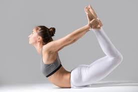 Download Young Woman In Dhanurasana Pose Grey Studio Background For Free In 2020 Yoga Poses Daily Workout Yoga Poses For Beginners