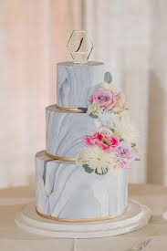Stunning Wedding Cake With Marble Icing Tiers Dressed With Fresh Flowers In Blush White And Pink And Ban Wedding Cake Marble Marble Wedding Gold Wedding Cake