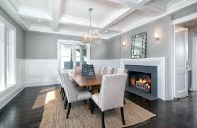The way gray works surprisingly well with yellow is proof of the incredible versatility of gray. Gray Dining Room Dining Room With Silver Chandelier White Wainscoting Dark Wood Floors And Gray Painted Walls Blue Gray Dining Room Walls
