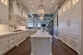 Our design innovations have simplified the installation and inspection process for wood hoods. Formal White Kitchen With Custom Clock Hood Crystal Cabinets