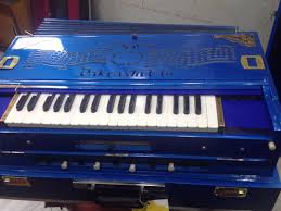 Pakrashi Harmonium Harmonium double reeds, 3 1/2 octaves, 9 stops, 4 extra notes, multifold bellows, coupler , bina special reeds, organ tune, shaped full cover, bright nickeled knobs, with glass frame on keys and double back valve, in a highly finished teak wood cabinet. pakrashi harmonium