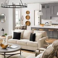 The darker grey accents in the area rug, pillows, hanging lights, lampshades, and swivel armchairs bring contrast and character to this simple design. Beige Coral Print Living Room Accent Chairs Design Ideas