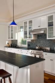 Transitional kitchen with a trough sink and two faucets designed with white cabinets and black leather granite countertops. 50 Black Countertop Backsplash Ideas Tile Designs Tips Advice