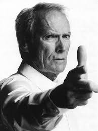 He is pointing the guns he holds in each hand toward the camera. Clint Eastwood Photo 3 20