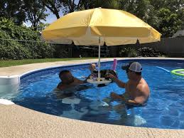 This Umbrella Table For Your Pool Doubles As A Shady Bar To Sit Down And Stay Protected From The Sun How Cool Is That Pool Shade Swimming Pools Pool Slide Diy