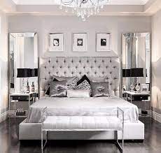 A Modern Bedroom Design In Grey With A Pair Of Rectangular Mirrors Behind The Nightstand Glamorous Bedroom Decor Glamourous Bedroom Master Bedrooms Decor