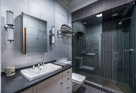 Masculine bathroom features top half of walls clad in brown grasscloth and lower half of walls clad in ivory shiplap trim lined with a tortoise shell mirror illuminated by polished nickel swing arm sconces and a black marble top washstand. 97 Stylish Truly Masculine Bathroom Decor Ideas Digsdigs