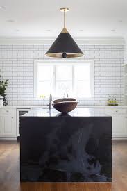 Black Marble Waterfall Countertop On The Kitchen Island White Cabinetry With Black Island White S Marble Kitchen Island Kitchen Marble Waterfall Countertop