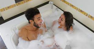 What are your friends reading? Young Couple Relaxing In Bath Together Blowing Foam Man And Woman Lover Enjoy Spa At Home Slow Motion 60