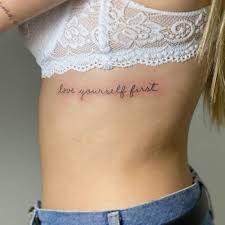 But it makes for a stunning design. Love Yourself Fisrt Rib Tattoo