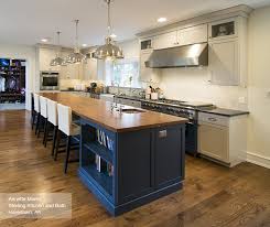 White cabinetry and a mosaic tile backsplash contrast with black. Off White Cabinets With A Blue Kitchen Island Omega