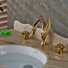 Faucet uses durable washerless cartridges and features a 1.2 gpm/4.5 lpm water flow rate. Juno Swan Gold Finish Dual Handle Wall Mount Brass Bathroom Sink Faucet