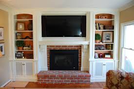 When is it okay to place a tv over the fireplace? Over Mantel Tv Cabinetry Tv Over Fireplace Home Fireplace Fireplace Shelves