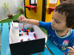 At AMI Daycare & Learning Center, every little roll sparks creativity and  learning! From colorful balls to tiny hands, our muffin pan activity is a  playful way to build coordination and explore