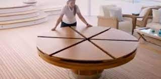 This expanding circular dining table is veneered in a 24 piece starburst pattern in pippy oak. Creative Design Of Expandable Round Dining Table