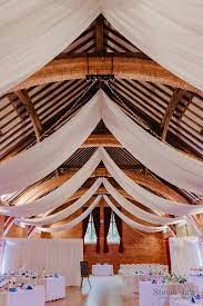 Thoresby Riding Hall Industrial Barn Wedding Venue With White Ceiling Drapes Industrial Barn Wedding Barn Wedding Decorations Artistic Wedding Photography