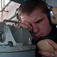 Quartermaster 3rd Class Nickolas Gibson checks bearings