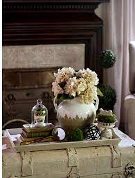 She has a clear bottle holding flags, 3. How To Style A Simple Coffee Table Vignette Styled Tray Ideas Coffee Table Vignettes Simple Coffee Table Table Vignettes