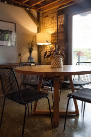 The room opens up into a dining space with simple furniture and statement plants for decor. Mid Century Modern Table Versatile Round Kitchen Dining Atlanta Custom Furniture Design Rustic Trades Furniture Blog