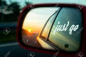 Motivation Quote Just Go With Sunset Reflection In The Rear View Mirror Of A Car On A Highway Stock Photo Picture And Royalty Free Image Image 55670099