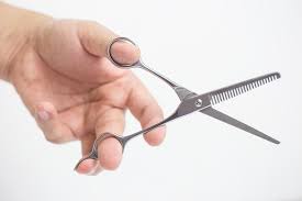 The hair is separated into sections. How To Use A Pair Of Thinning Scissors