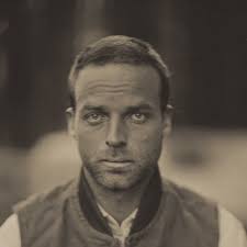 a woman is straddling the barrier of an overpass in south austin