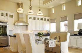 The allure of dark kitchen cabinets is obvious—they're dramatic, striking, and demand your attention immediately upon entering the room. White Sand Paint Colors Huge Eat In Kitchen Design With Soft Tan Sand Walls Paint Color Bench Seating Kitchen Painting Kitchen Cabinets White Kitchen Benches