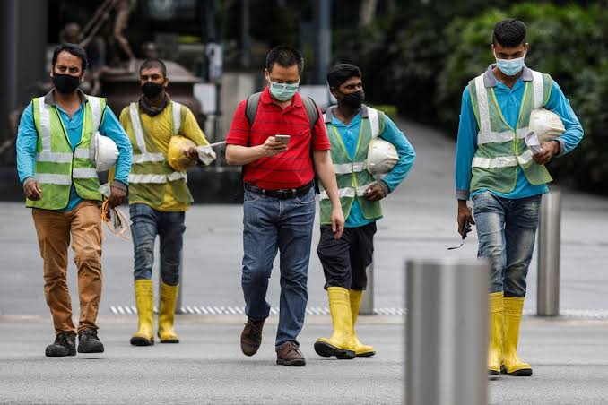 Singapore's migrant workers fear financial ruin after virus ordeal | Reuters