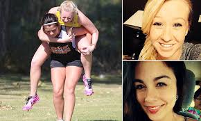 Touching moment a North Dakota cross country runner carries competitor  across the finish line after she badly injures her leg