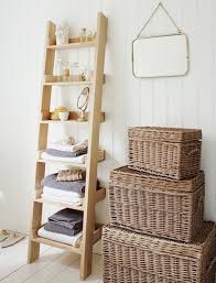 how to store towels 9 storage hacks purewow small bathroom storage ladder storage oak ladder shelf