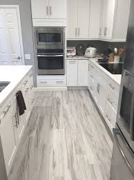 Gray And White Kitchen Luxurious Transitional Kitchen 12 X 24 Kitchen Ideas Is Accented With Transitional Kitchen Islands Kitchen Wall Color Kitchen Transi Grey Laminate Flooring Kitchen Grey Wood Floors