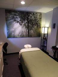 The fresh green color makes the narrow dark room feel larger. Come Relax In Our Massage Room I Like Everything In This Room Massage Room Massage Room Decor Massage Therapy Rooms