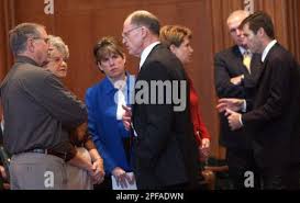 Police and members of Eric Miller's family talk with state attorneys before  arguments are made Tuesday, Oct. 15, 2002, in Raliegh, N.C. They are, from  left, Verus, and Doris Miller, Eric's parents,