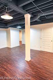 A beautiful stained shiplap ceiling was added to the living room. Tales Of Painted Basement Ceilings And Pole Dancing Woes Beth Bryan