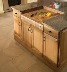 Shaped to sit alongside your kitchen sink, this cutting board fits over the edge of any countertop to provide secure positioning. Yorktowne Cabinetry Built In Chopping Block