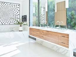 Brass sconces on both sides of the mirror add unique, vintage detail to this main bathroom space. 17 Ways To Decorate With White In The Bathroom
