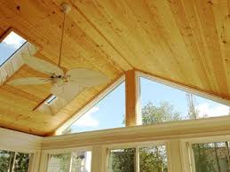 Skylights And A Beautiful Pine Cathedral Ceiling Give This Sunroom An Open And Sunny Fe Cathedral Ceiling Living Room Vaulted Ceiling Living Room Small Sunroom