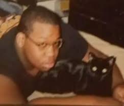 This is a picture of my cousin with his cat, Kai. Sorry the picture is a  bit blurry, but it's the only one I have of the both of them and will