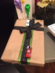 Holiday Christmas Gift Wrapping Ideas Get Kids Excited About Giving Them Clothes By Christmas Tree With Gifts Holiday Christmas Gifts Christmas Gift Wrapping