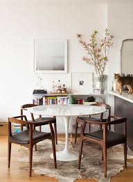 Tulip Table Wood Chairs Hide Rug White Walls Cat Mid Century Modern Dining Room