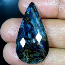 The Beauty And Essence Of Storm Is Captured In Pietersite With Brilliant Flashes Of Golden Light Amid Churning Clouds O Stones And Crystals Gemstones Crystals